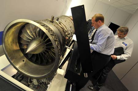 Visitors examine the EJ200 engine of a Rafele battleplane at an airshow in Bangalore, India, Feb. 11, 2009. 