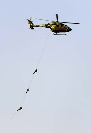 An Indian army helicopter performs during the opening ceremony of an airshow in Bangalore, India, Feb. 11, 2009. 