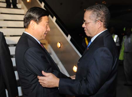 Chinese Vice President Xi Jinping (L) is greeted by Jamaican Prime Minister Bruce Golding upon his arrival in Kingston, capital of Jamaica, on Feb. 11, 2009. Jamaica is the second leg of Xi's six-nation tour, which has taken him to Mexico and will take him to Colombia, Venezuela, Brazil and Malta. 