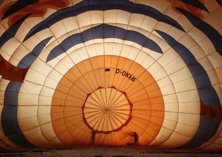 A balloonist checks a hot air balloon before take-off at the start of the 14th Philippine International Hot Air Balloon Week at Clark airbase in Pampanga province, north of Manila, February 12, 2009.