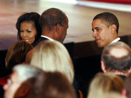 U.S President Barack Obama (R) and first lady Michelle Obama meet actor Sidney Poitier (L) as they arrive at a celebration of the Lincoln Bicentennial and Ford's Theatre Grand reopening in Washington, February 11, 2009. 