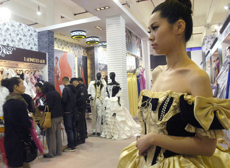 A model displays a wedding dress at the 15th Shanghai International Wedding Photographic Equipment Exhibition in Shanghai, east China, Feb. 12, 2009. The four-day exhibiton opened on Thursday with about 500 enterprises from home and abroad attending. 