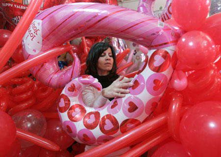 A vendor displays heart-shaped balloons for Valentine&apos;s Day in a shop in Beirut February 13, 2009.