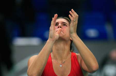 Amelie Mauresmo of France celebrates after winning the final match over Elena Dementieva of Russia in the Paris Open tennis tournament in Paris, France, Feb. 15, 2009. 