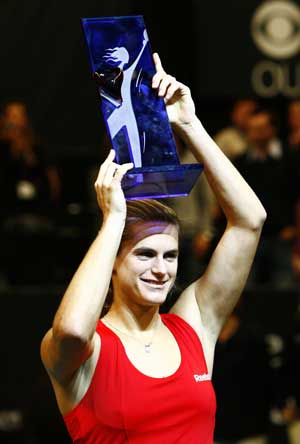 Amelie Mauresmo of France celebrates with the trophy during the awarding ceremony after winning the final match over Elena Dementieva of Russia in the Paris Open tennis tournament in Paris, France, Feb. 15, 2009. Mauresmo won the match 2-1. 