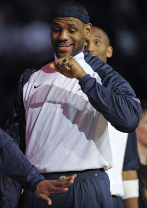 Cleveland Cavaliers' LeBron James looks at his ring during a ceremony where the players were presented rings for wining the gold medal at the Olympics in Beijing of China last year, during halftime at the NBA All-Star basketball game in Phoenix, Arizona of the United States, Feb. 15, 2009. [Xinhua]