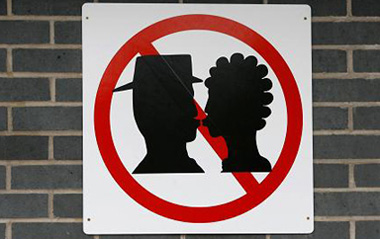 A No Kissing sign is displayed outside Warrington Bank Quay railway station in Warrington, northern England, February 16, 2009.