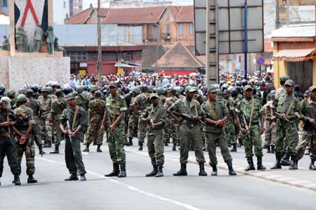 Madagascan policemen and soldiers guard a street in Antananarivo Feb. 16, 2009. Madagascan opposition leader Andry Rajoelina on Monday evening asked the government of his rival President Marc Ravalomanana to define the limit of the 'red zones' because his supporters will gather in front of the ministerial buildings on Tuesday.[Xinhua]