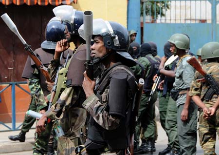 Madagascan policemen and soldiers guard a street in Antananarivo Feb. 16, 2009. Madagascan opposition leader Andry Rajoelina on Monday evening asked the government of his rival President Marc Ravalomanana to define the limit of the 'red zones' because his supporters will gather in front of the ministerial buildings on Tuesday.[Xu Suhui/Xinhua]