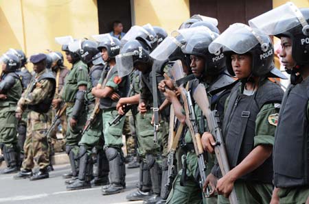 Madagascan policemen and soldiers guard a street in Antananarivo Feb. 16, 2009. Madagascan opposition leader Andry Rajoelina on Monday evening asked the government of his rival President Marc Ravalomanana to define the limit of the 'red zones' because his supporters will gather in front of the ministerial buildings on Tuesday.[Xu Suhui/Xinhua]