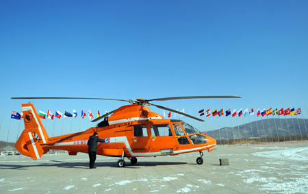 A helicopter is ready to takes off from the parking apron of Yabuli Ski Resort, 195km southeast away from Harbin City, capital of northeast China's Heilongjiang Province, Feb 17, 2009. The 24th World Winter Universiade will start on Feb. 18 in Harbin. Sports including Alpine Skiing, Cross-Country Skiing, Ski Jumping, Nordic Combined, and Freestyle Skiing will be competed at the Yabuli Ski Resort from Feb. 20.[Xu Yu/Xinhua]