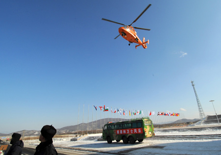 A helicopter takes off from the parking apron of Yabuli Ski Resort, 195km southeast away from Harbin City, capital of northeast China's Heilongjiang Province, Feb 17, 2009.[Xu Yu/Xinhua]