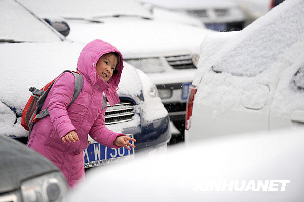 A girl plays in snow in Beijing, capital of China, Feb. 17, 2009. The icy weather gripped the city on Tuesday morning. (Xinhua/Li Jundong) 