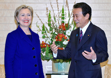 Japanese Prime Minister Taro Aso (R) shares a light moment with visiting U.S. Secretary of State Hillary Clinton (L) prior to their meeting at Aso's official residence in Tokyo, capital of Japan, Feb. 17, 2009. [Xinhua/Toru Yamanaka/Pool]