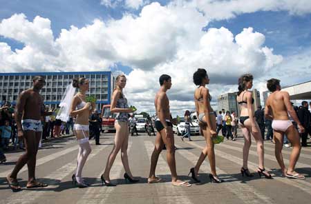 Models walk around a bus station during the third edition of the Brazilian version of the Underwear Day in Brasilia, Tuesday, Feb. 17, 2009. [Xinhua/AFP]