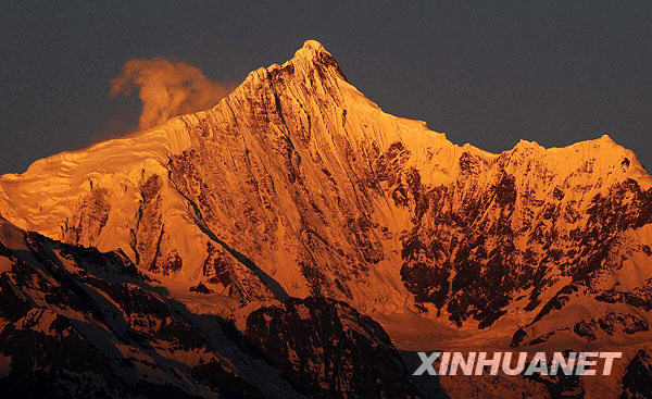 Meili Snow Mountain is illuminated at sunrise in Deqin, Southwest China's Yunnan Province, Feb. 16, 2009. As one of the 118 snow-capped mountains stand 5,000 meters high above sea level in the Three Parallel Rivers region, the Meili Snow Mountain rises 6,740 meters high and its peak is covered with glaciers formed thousands of years ago. [Xinhua] 