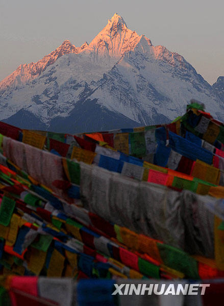 The Meili Snow Mountain is illuminated at sunrise in Deqin, Southwest China's Yunnan Province, Feb. 16, 2009. [Xinhua] 