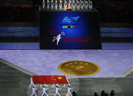 Chinese national flag is escorted into Harbin International Conference, Exhibition and Sports Centre Gym at the opening ceremony of the 24th World Winter Universiade in Harbin, capital of northeast China's Heilongjiang Province, Feb.18, 2009. [Guo Dayue/Xinhua]