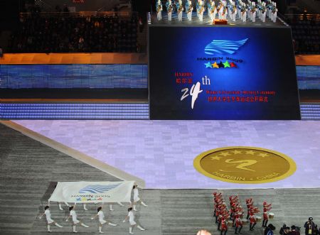 The flag of 24th World Winter Universiade is escorted into Harbin International Conference, Exhibition and Sports Centre Gym at the opening ceremony of the 24th World Winter Universiade in Harbin, capital of northeast China's Heilongjiang Province, February 18, 2009. [Xinhua]