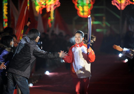 Torchbearers runs into Harbin International Conference, Exhibition and Sports Centre Gym at the opening ceremony of the 24th World Winter Universiade in Harbin, capital of northeast China's Heilongjiang Province, Feb.18, 2009. [Xinhua]