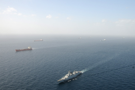 The 'Wuhan' vessel of the Chinese navy (Below) escorts merchant vessels in the Gulf of Aden, on Feb. 17, 2009.[Zhu Hongliang/Xinhua] 