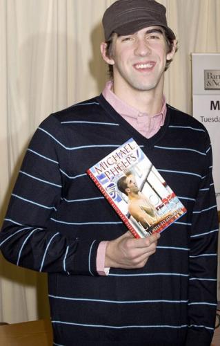 This undated photo shows the Olympic champion swimmer Michael Phelps promoting his new book,'No Limits: The Will to Succeed'. He will not face prosecution over a photo showing him smoking marijuana at a party last year. [sports.sohu.com]