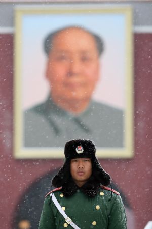 A Chinese armed police soldier stands guard on the Tian'anmen Square during a snowfall in Beijing Feb. 18, 2009. Rain and snowfall have helped ease a severe drought in northern and eastern China. [Zhuo Ensen/Xinhua]