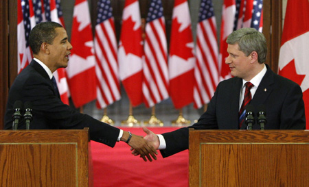 US President Barack Obama (L) and Canadian Prime Minister Stephen Harper shake hands before a news conference on Parliament Hill in Ottawa, February 19, 2009. [China Daily/Agencies] 