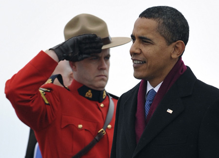 US President Barack Obama walks past an RCMP honor guard after arriving in Ottawa, February 19, 2009. [China Daily/Agencies] 