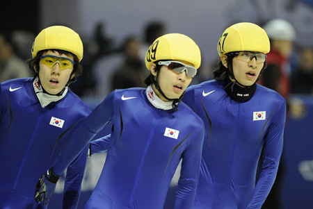Gold medalist Lee Seung Hoon (R), silver medalist Kim Seoung Il (L) and bronze medalist Yun Tae Sik of South Korea react after the men's 1500m short track speed skating finals at the 24th World Winter Universiade in the Harbin University of Science and Technology Skating Gym of Harbin, capital of northeast China's Heilongjiang Province, Feb. 19, 2009. 