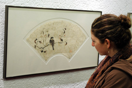 A woman visits a painting by Fanya Pines during an exhibition in Jerusalem, Feb. 19, 2009. Fanya Pines was born in China's Tianjin in 1922 and immigrated to Israel in 1952. She began to learn Chinese Painting by herself at the age of 63.