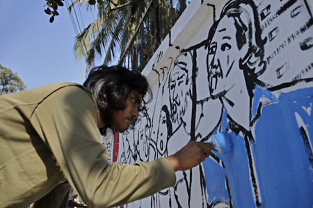 An artist draws a painting on the wall around the Central Shaheed Minar (unseen), the monument for Bangladesh's Language Movement martyrs, in Dhaka, Bangladesh, Feb. 20, 2009. The Bangladeshi people are preparing to mark the 10th International Mother Language Day, which falls on Feb. 21 and is observed in recognition of Bangladesh's 1952 Language Movement. [Xinhua Photo]