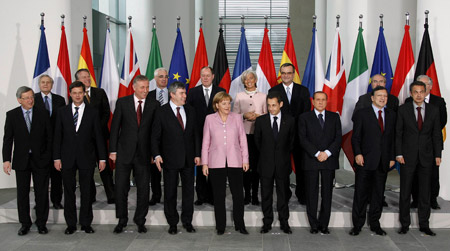  German Chancellor Angela Merkel (C) pose with European leaders for a family picture after a meeting in the Chancellery in Berlin, Feb. 22, 2009. European leaders met in Berlin on Sunday to agree a common stance on overhauling global financial rules but their summit risked being overshadowed by concerns about the fragility of euro zone and eastern European states.[Xinhua/Reuters]