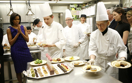 Chefs bring out dishes as US first lady Michelle Obama gives a dinner preview for Sunday's Governors dinner at the White House in Washington February 22, 2009. [China Daily/Agencies]