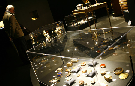 A visitor watches artworks displayed on the preview of the auction of Yves Saint Laurent and Pierre Berge's art collection at the Grand Palais in Paris, France, Feb. 21, 2009. [Zhang Yuwei/Xinhua] 