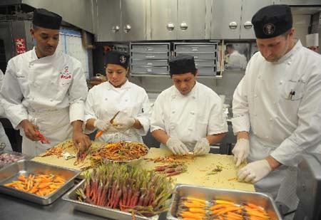 White House kitchen staff work on the Governors dinner at the White House in Washington February 22, 2009.[Xinhua/AFP]