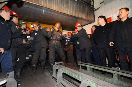 Rescue workers carry a body of a victim at a coal mine in north China's Shanxi Province, Feb. 22, 2009.