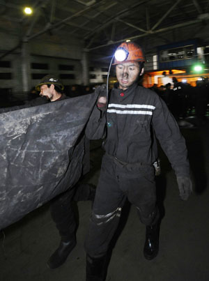 Rescue workers carry a body of a victim at a coal mine in north China's Shanxi Province, Feb. 22, 2009. 