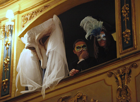 Revellers sit in a theatre box during a masked carnival ball at the Manoel Theatre, built in 1731, in Valletta early February 22, 2009.[Xinhua/Reuters]