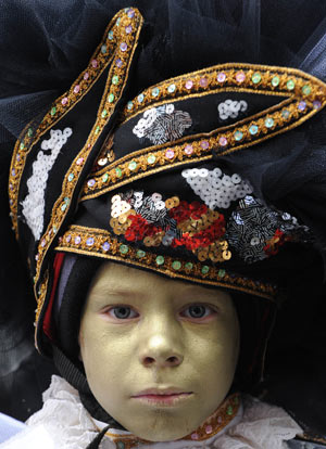 A boy in carnival costume takes part in parade in the first day of carnival celebration in Binche, about 50 km south of Brussels, capital of Belgium Feb. 22, 2009.[Wu Wei/Xinhua]