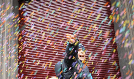 A boy scatters the confetti in the first day of carnival celebration in Binche, about 50 km south of Brussels, capital of Belgium Feb. 22, 2009.[Wu Wei/Xinhua] 