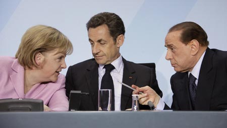 German Chancellor Angela Merkel, France's President Nicolas Sarkozy and Italy's Prime Minister Silvio Berlusconi (L-R) chat at a news conference after a meeting in Berlin, February 22, 2009. European leaders met in Berlin on Sunday to agree a common stance on overhauling global financial rules but their summit risked being overshadowed by concerns about the fragility of euro zone and eastern European states.