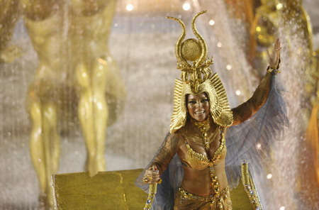 A reveller of Beija-Flor samba school dances during the first night of the Carnival parade in Rio de Janeiro's Sambadrome, early February 23, 2009. [China Daily/Agencies]