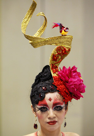 A contestant poses while wearing a spring-themed head dress before a nail art competition at the BeautyAsia expo in Singapore February 23, 2009. [Xinhua/Reuters]