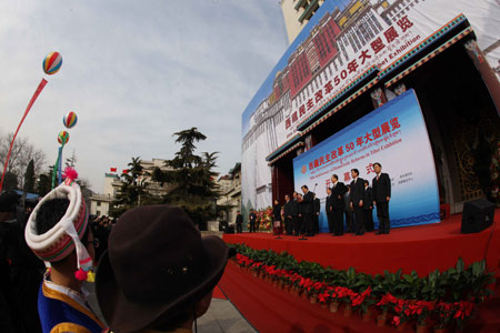 People take part in the opening ceremony of an exhibition marking the 50th anniversary of the Democratic Reform in Tibet Autonomous Region in Beijing, China, Feb. 24, 2009. [Xinhua]