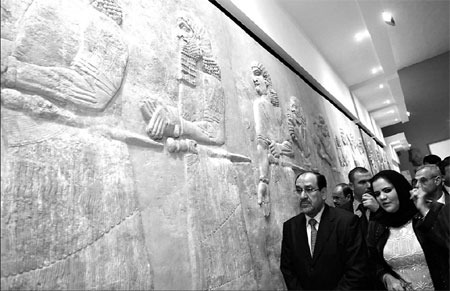 Iraqi Prime Minister Nuri al-Maliki looks at a stone relief at the Iraqi National Museum during an opening ceremony yesterday