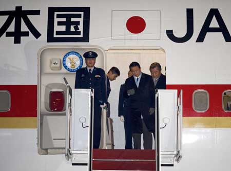 Prime Minister Taro Aso of Japan arrives at Andrews Air Force Base in Maryland on Monday, Feb. 23, 2009. Aso was set Tuesday to be President Barack Obama's first foreign guest as the leaders of the world's two largest economies plot action on the global financial crisis. [Xinhua/AFP]