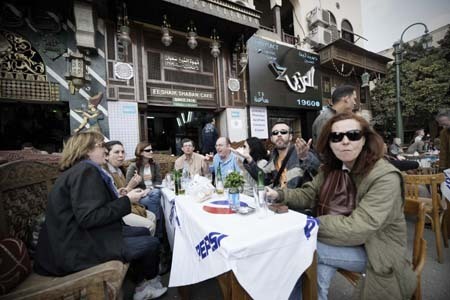 Tourists from Spain drink coffee at the Khan Al-Khalili bazaar in Cairo, capital of Egypt, Feb. 23, 2009. Shops and restaurants around the Hussein mosque square and in the Khan Al-Khalili bazaar reopened for business on Monday, although two bombs blew up Sunday evening in this populous district, which had killed a French tourist and injured 24. [Xinhua]