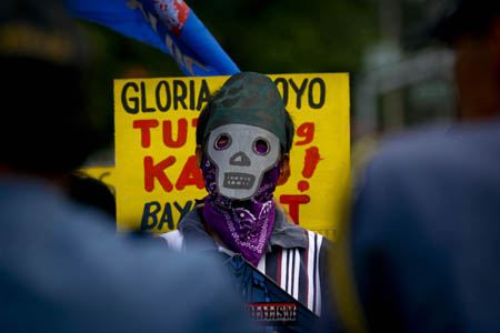 A man wearing a mask takes part in a rally in Manila, capital of Philippines, Feb. 24, 2009. 