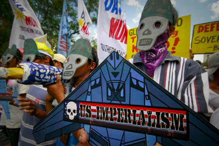 Protesters wear masks as they try to march towards the U.S. Embassy during a rally in Manila, capital of the Philippines, Feb. 24, 2009. 